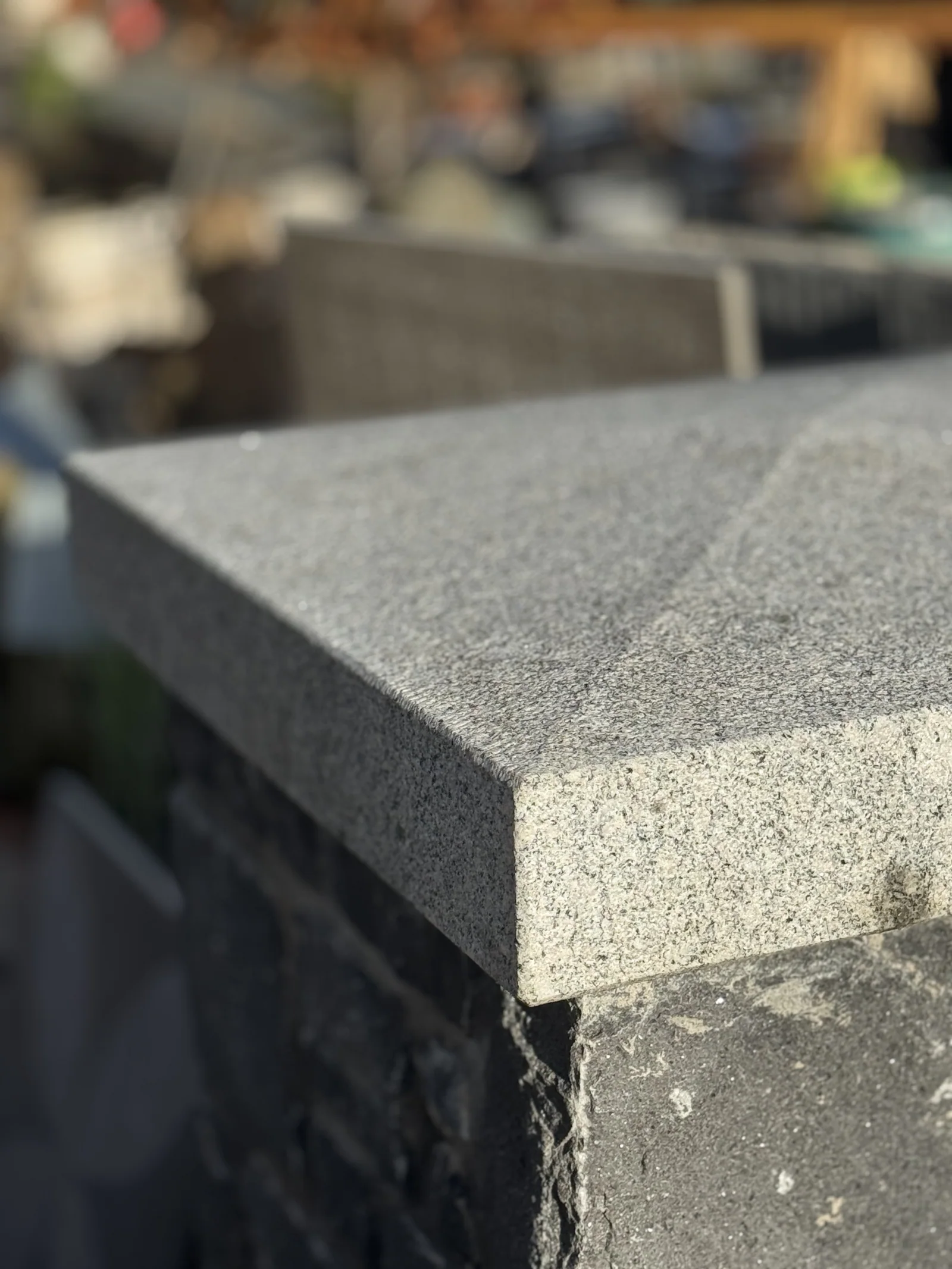 Close-up of a bespoke capstone edge profile on a garden pier