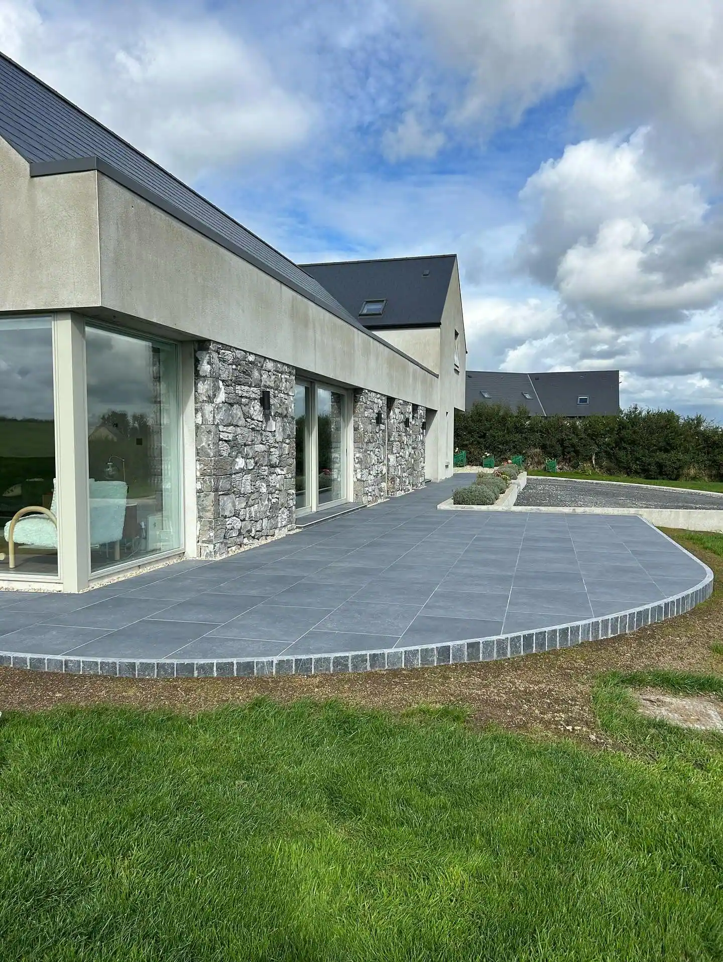 Modern house with a curved paved path and gravel border