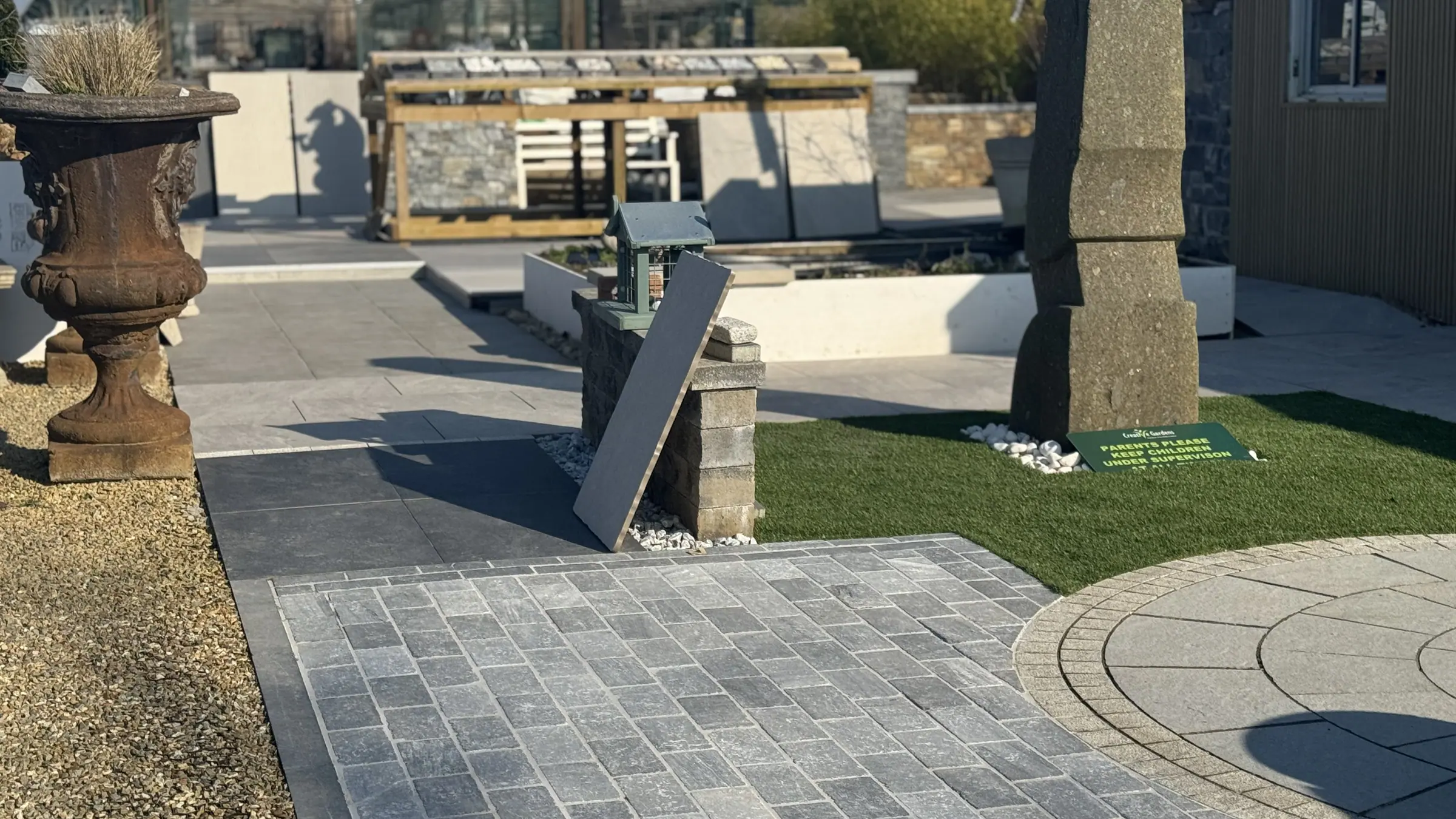 Display garden with paving and pier capstones at Creative Gardens