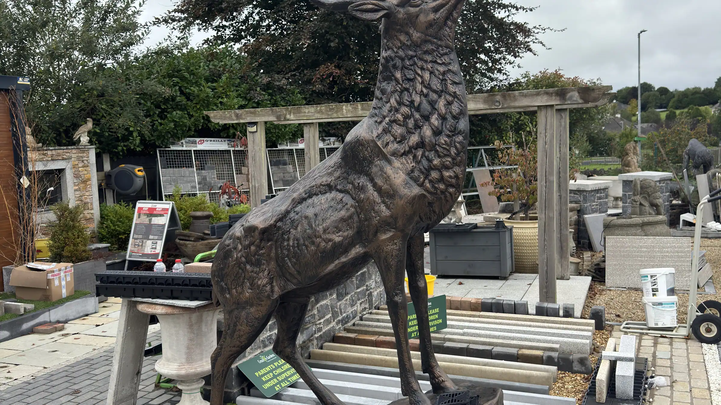 Display garden at Creative Gardens with paving, planting and a stag statue