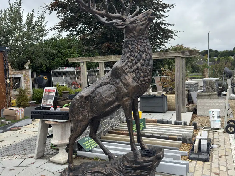 Display garden at Creative Gardens with paving, planting and a stag statue